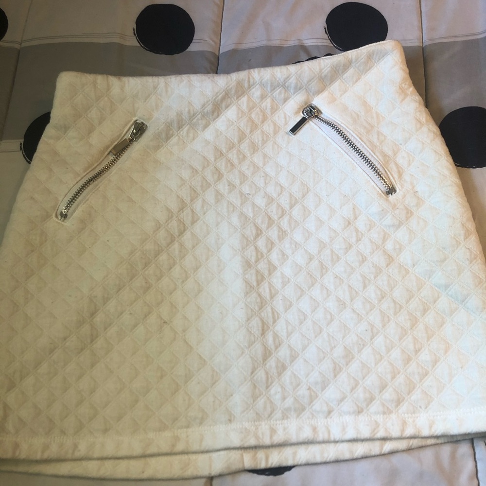 White shirt with zippers .